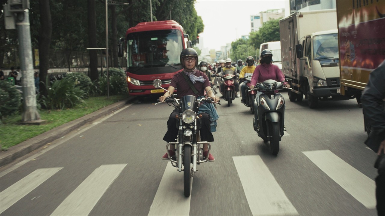 People on motorbikes on a busy road